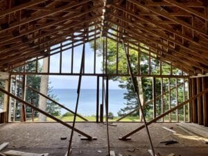 addition during rough framing construction on lakeshore with view of lake
