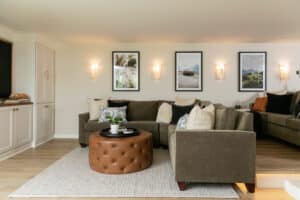 finished basement remodel corner of room with white cabinets, green couches, and vinyl plank flooring